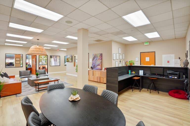 Launch To Wellness communal table, reception area, and lounge