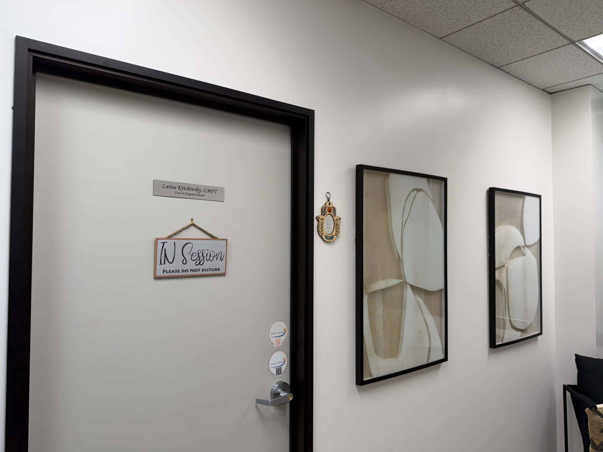 Office door and hamsa on the wall beside it