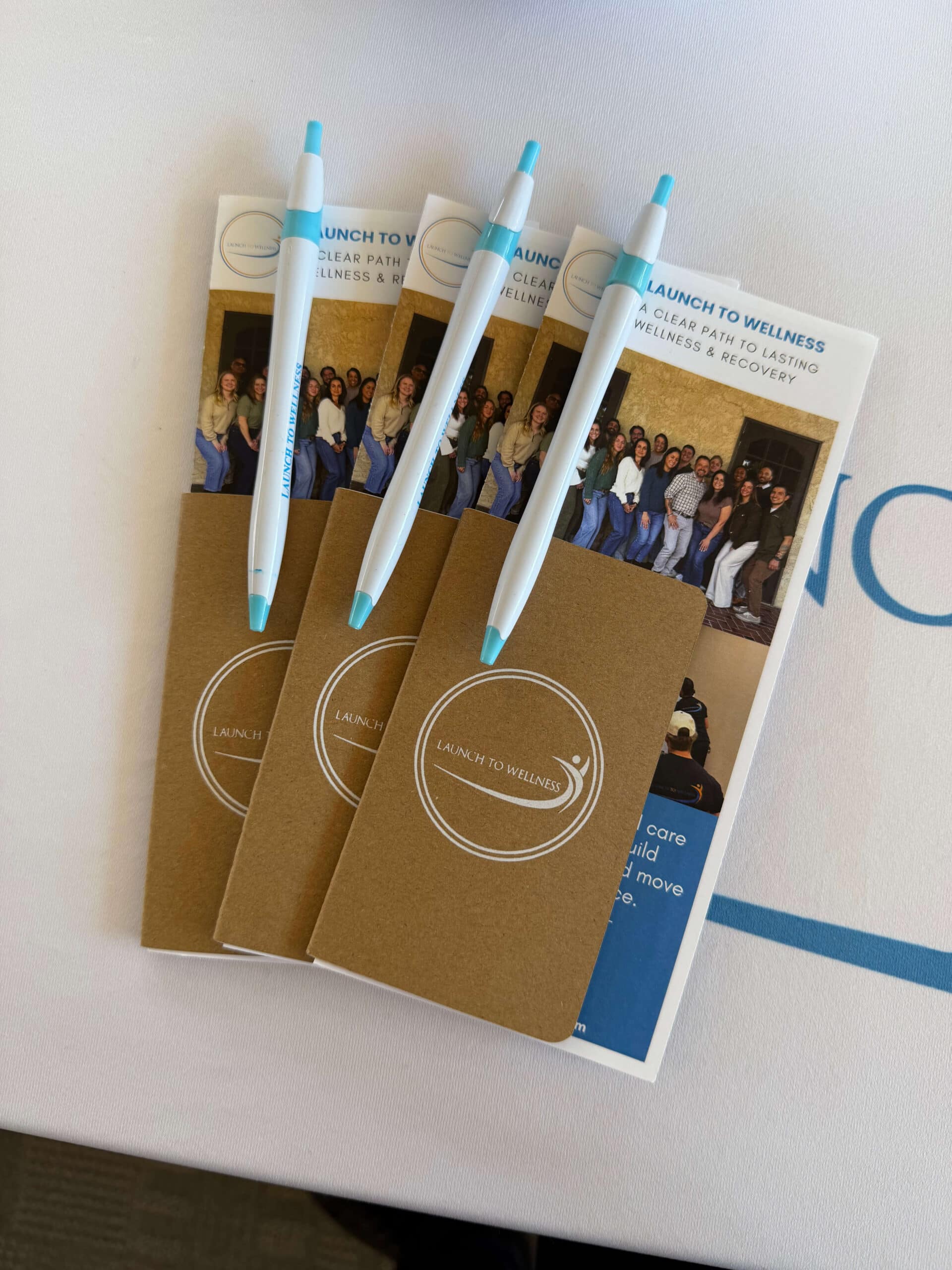 Launch To Wellness pens, notebooks, and brochures at a community event