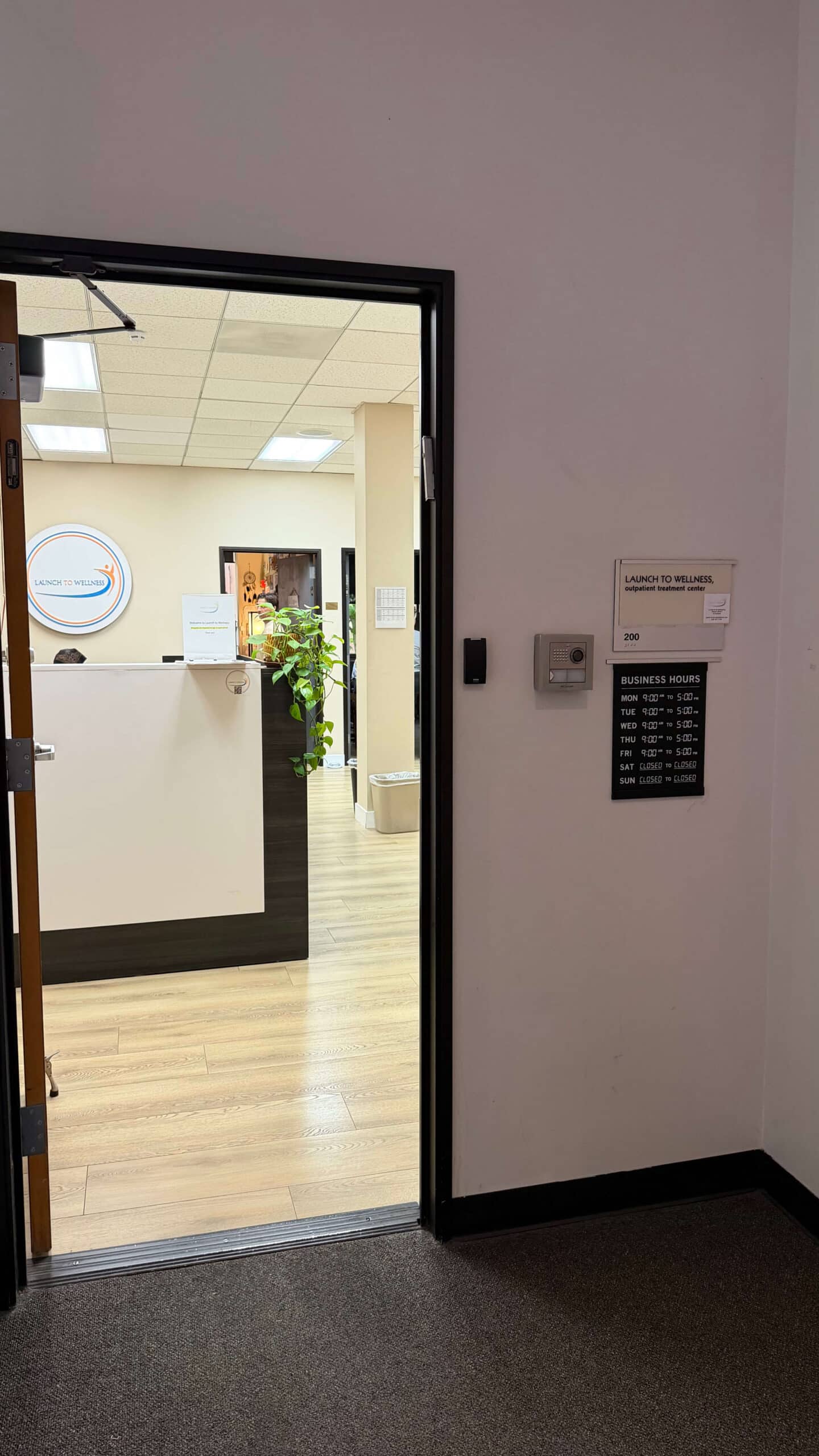 The doorway into the Launch To Wellness outpatient treatment center, with the reception desk beyond.